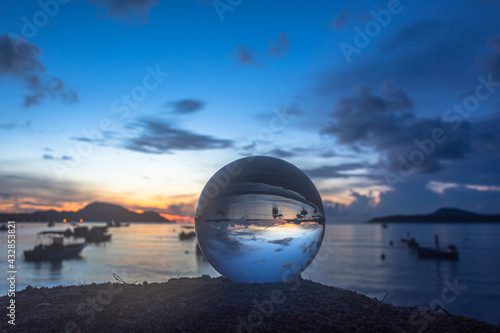 view of the sea and sky inside crystal ball. The natural view of the sea and sky are unconventional and beautiful. .A image for a unique and creative travel idea.