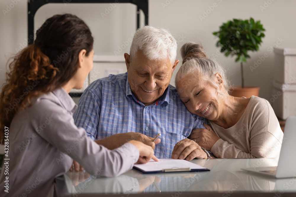 Reaching an agreement. Happy old spouses visiting lawyer broker realtor to buy real estate sign insurance policy create will. Excited aged married couple clients sign financial deal with bank manager Reaching an agreement. Happy old spouses visiting lawyer broker realtor to buy real estate sign insurance policy create will. Excited aged married couple clients sign financial deal with bank manager