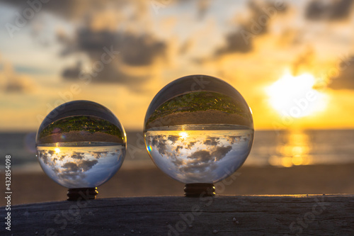 sunset sunrise view inside crystal ball..The natural view of the sea and sky are unconventional and beautiful. .A image for a unique and creative travel idea.