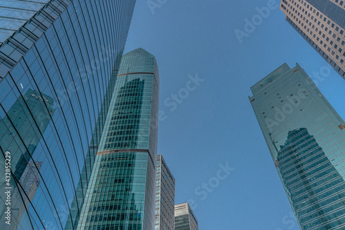 Low angle view of modern skyscraper with blue sky in Shanghai  China.