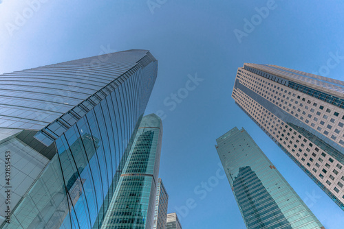 Low angle view of modern skyscraper with blue sky in Shanghai  China.