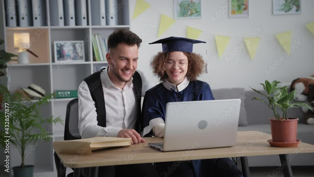 modern learning, happy young man and female student rejoice and hug each other at graduation ceremony online via laptop video link rejoicing graduation from college modern learning, happy young man and female student rejoice and hug each other at graduation ceremony online via laptop video link rejoicing graduation from college
