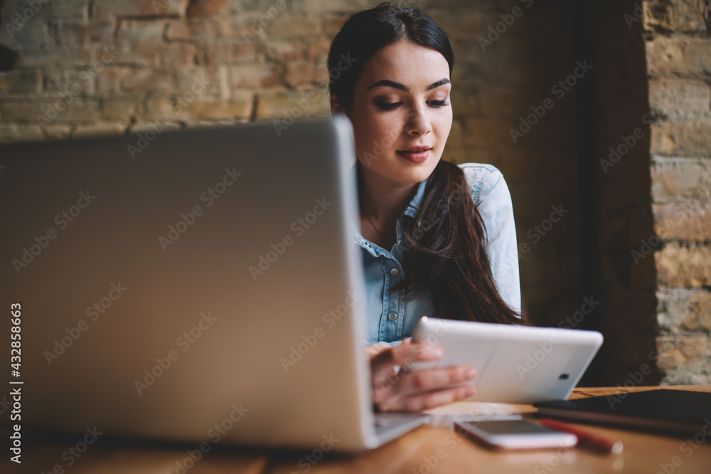 Thoughtful woman with tablet watching video Thoughtful woman with tablet watching video