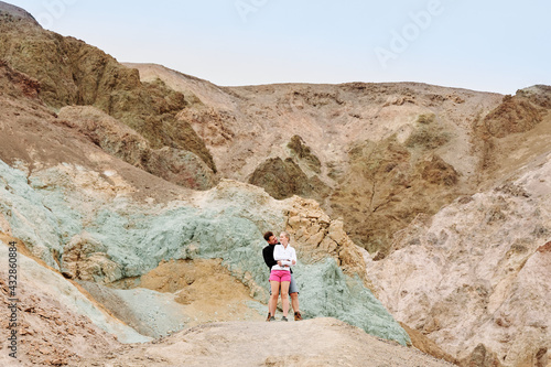 A family is hiking and enjoying the views in Death Valley national park in California, USA. It’s March 2021, the weather is warm and sunny. The views are stunning and the sand desert is spectacular. © Karina Eremina