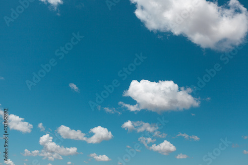 Blue beautiful sky with white clouds and sun