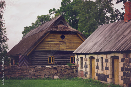 Wooden and stone houses. Rural landscape. The open air Museum in Tallinn. Retro toned.