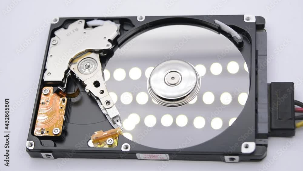 Video of Opened Hard Disk Drive with spinning platter. Close up of a hard disk drive reading and writing data. Disassembled hdd reading head. Video of Opened Hard Disk Drive with spinning platter. Close up of a hard disk drive reading and writing data. Disassembled hdd reading head.