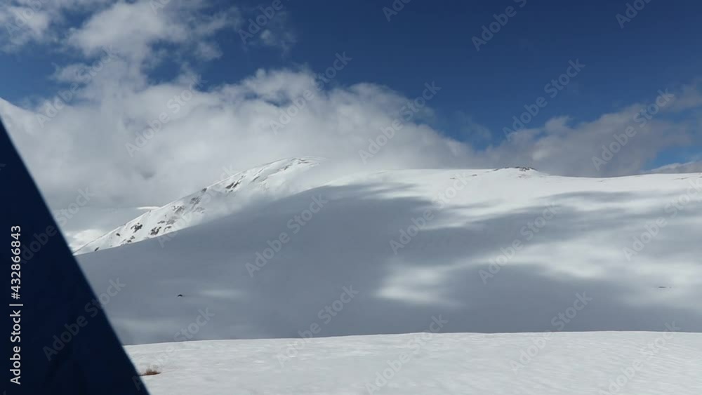 Amazing mountain landscape with snow and clouds at high altitude in winter Amazing mountain landscape with snow and clouds at high altitude in winter