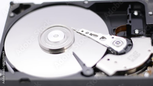 Wallpaper Mural Video of Opened Hard Disk Drive with spinning platter. Close up of a hard disk drive reading and writing data. Disassembled hdd reading head. Torontodigital.ca