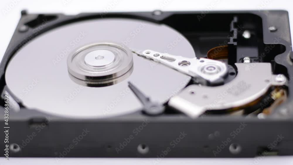Video of Opened Hard Disk Drive with spinning platter. Close up of a hard disk drive reading and writing data. Disassembled hdd reading head. Video of Opened Hard Disk Drive with spinning platter. Close up of a hard disk drive reading and writing data. Disassembled hdd reading head.