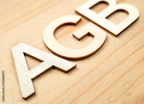 AGB wood letters. Selective focus on front with defocused letters to the back. German acronym or abbreviation for: AGB - Allgemeine Geschäftsbedingungen, meaning general terms and conditions. photo