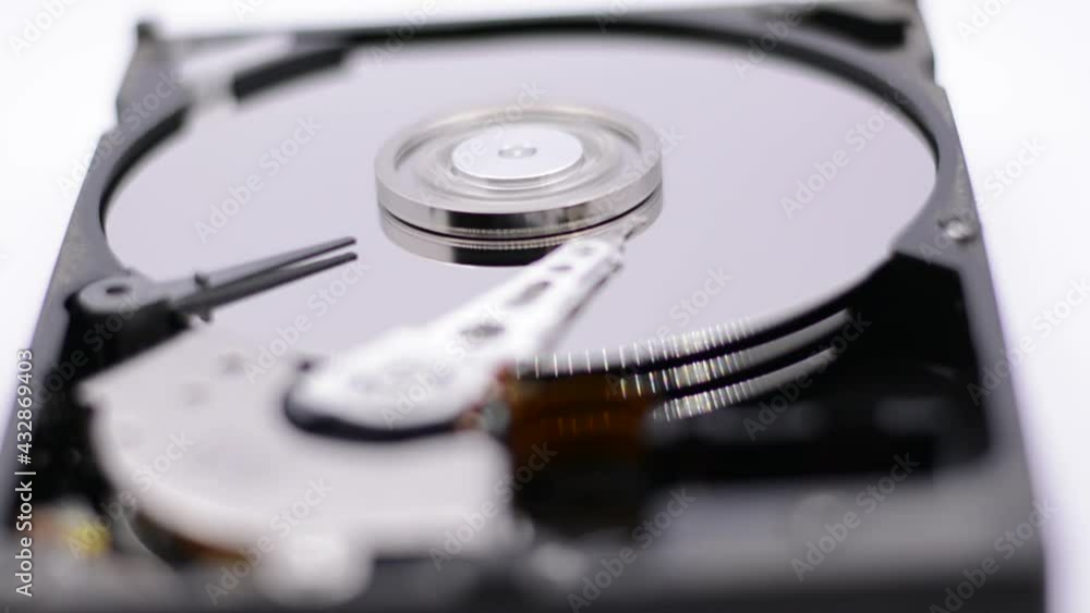 Video of Opened Hard Disk Drive with spinning platter. Close up of a hard disk drive reading and writing data. Disassembled hdd reading head. Video of Opened Hard Disk Drive with spinning platter. Close up of a hard disk drive reading and writing data. Disassembled hdd reading head.