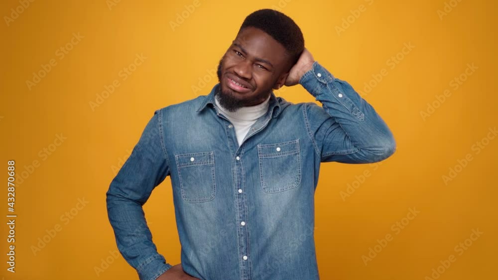 Young african american man thinking against yellow background Young african american man thinking against yellow background