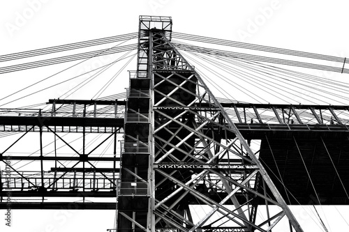 Newport Transporter Bridge, constructed in 1902 crosses the River Usk in Newport and is a grade 1 listed structure with cantilevered sections, the main girder truss gives it an overall length of 232m