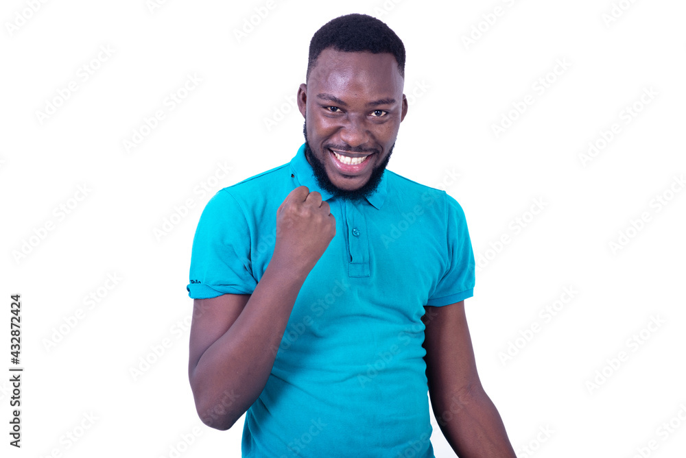 handsome young man showing winning gesture. handsome young man showing winning gesture.