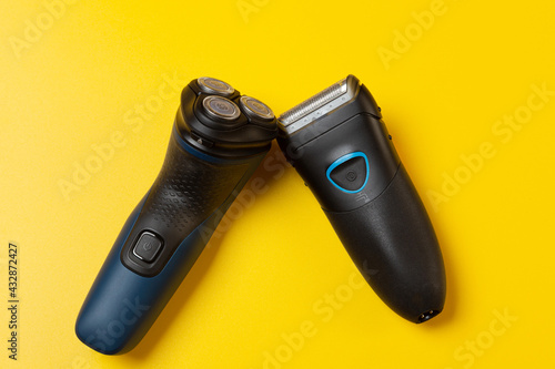 Фотография Foil and Rotary Electric Shavers on a yellow background