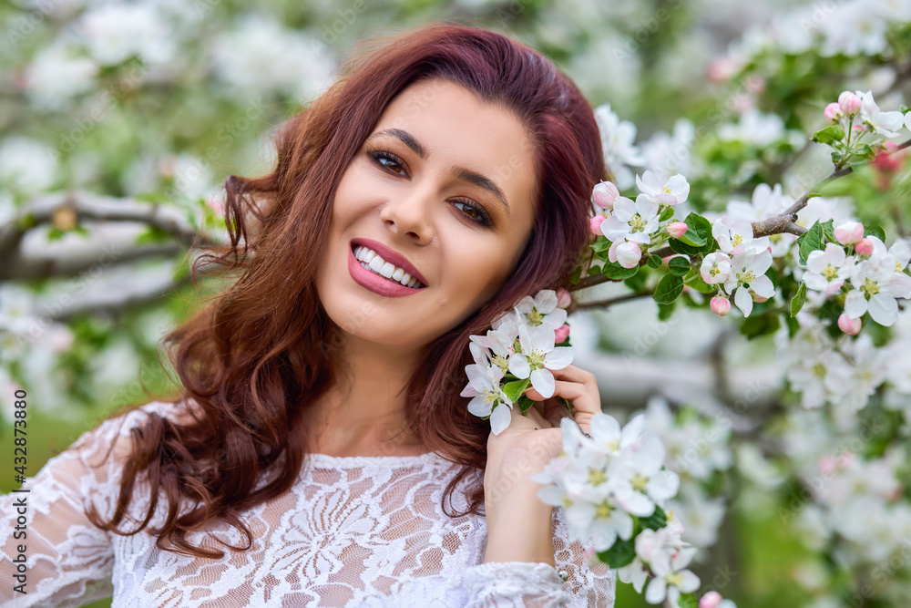 Beautiful natural woman in the garden of apple Beautiful natural woman in the garden of apple