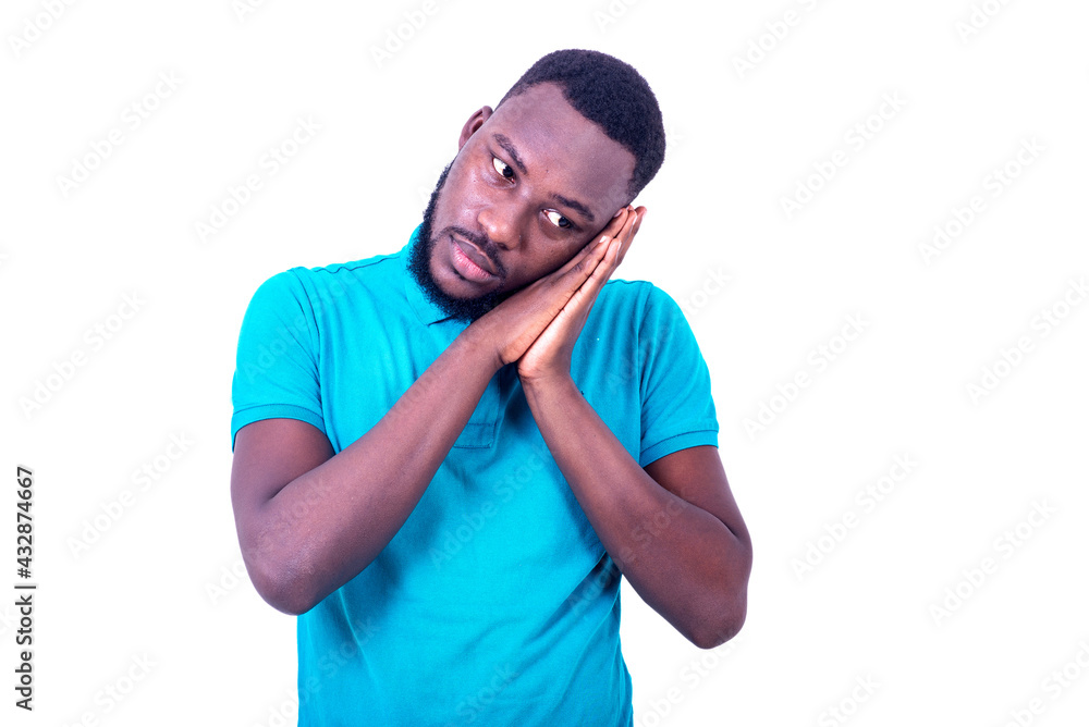 handsome young man with hands together under cheek. handsome young man with hands together under cheek.