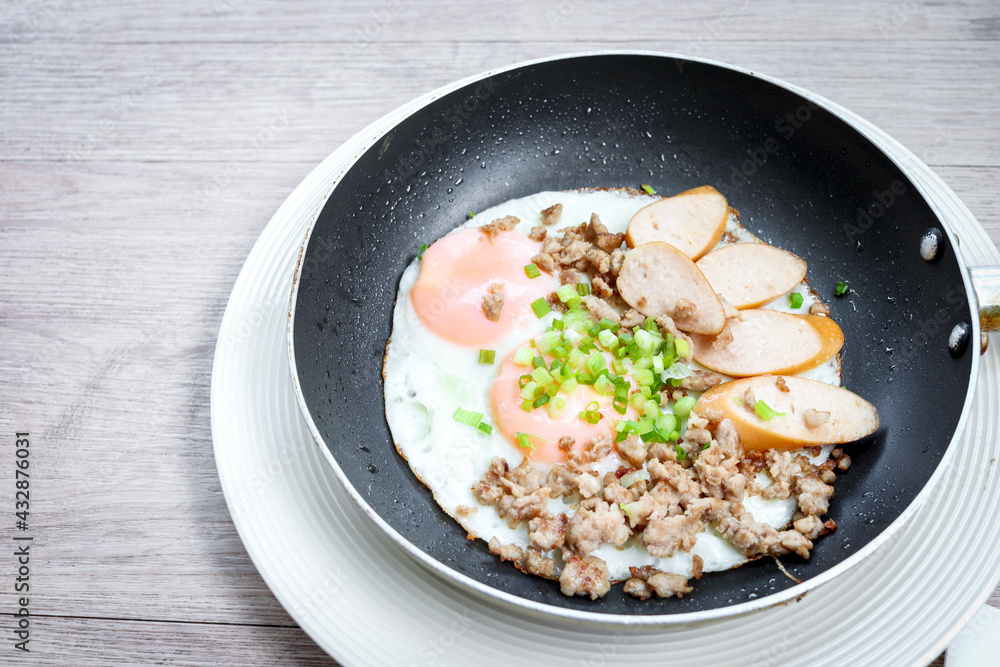 Pan-fried egg with toppings, hot breakfast in cooking served on table in morning. Pan-fried egg with toppings, hot breakfast in cooking served on table in morning.