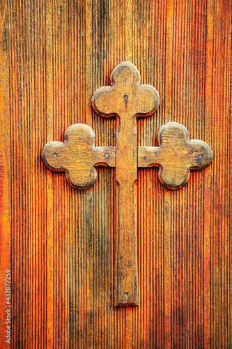 Cross made by wood on wooden background . Spiritual symbol of Christianity . Church religious decor photo