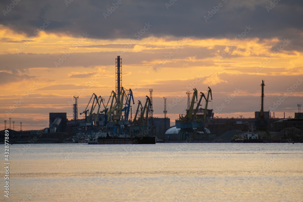 Smoking chimneys of an industrial plant at sunset. Ecological concept.