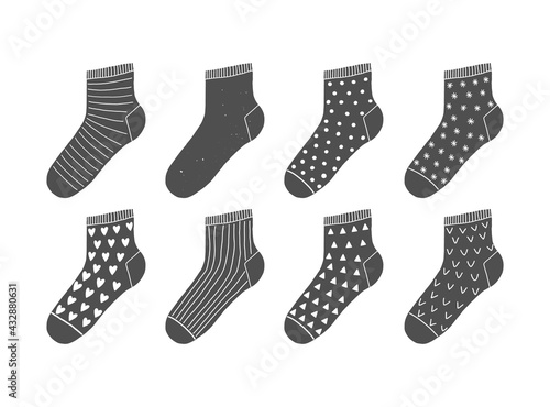 Set of 8 cute vector black socks with ornaments on white background. Scandinavian doodle illustrations.