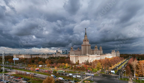 Aerial panoramic view of sunset campus buildings of famous Moscow university under dramatic cloudy sky in autumn