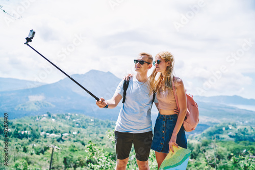 Couple standing and taking selfie near mountains #432881409