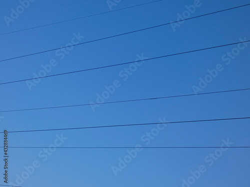 High voltage power line wires against sky