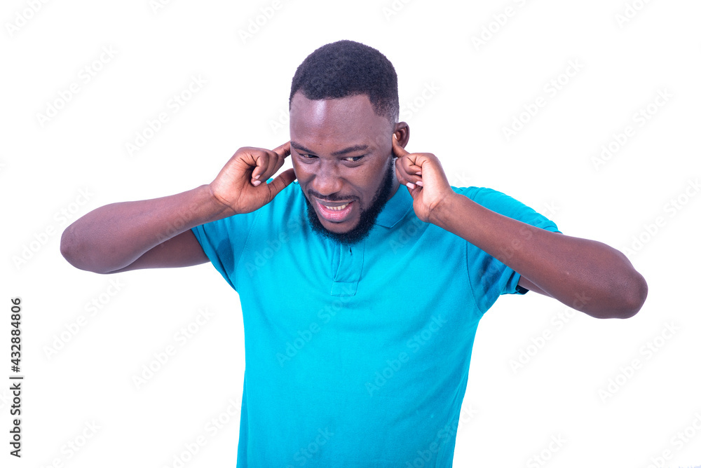 annoyed young man covering ears with fingers. annoyed young man covering ears with fingers.