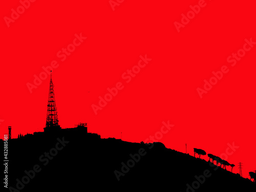Silhouette on the mountain of an analog radio antenna