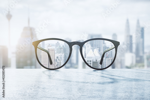 Clear view concept with eyeglasses with transparent lenses on marble surface and blurry city view on background