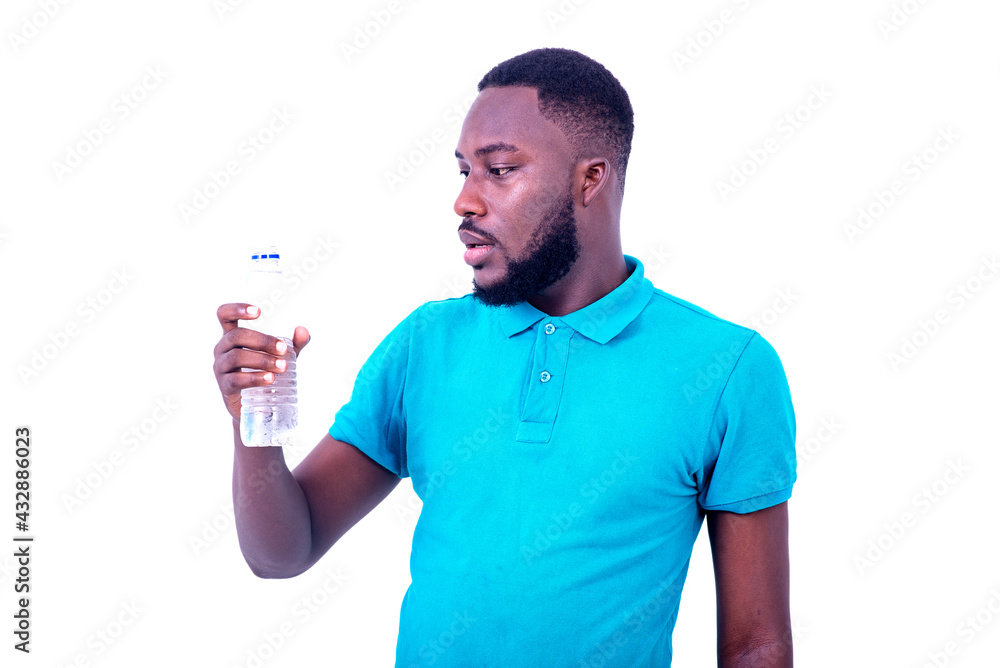 young man looking at a bottle of mineral water. young man looking at a bottle of mineral water.