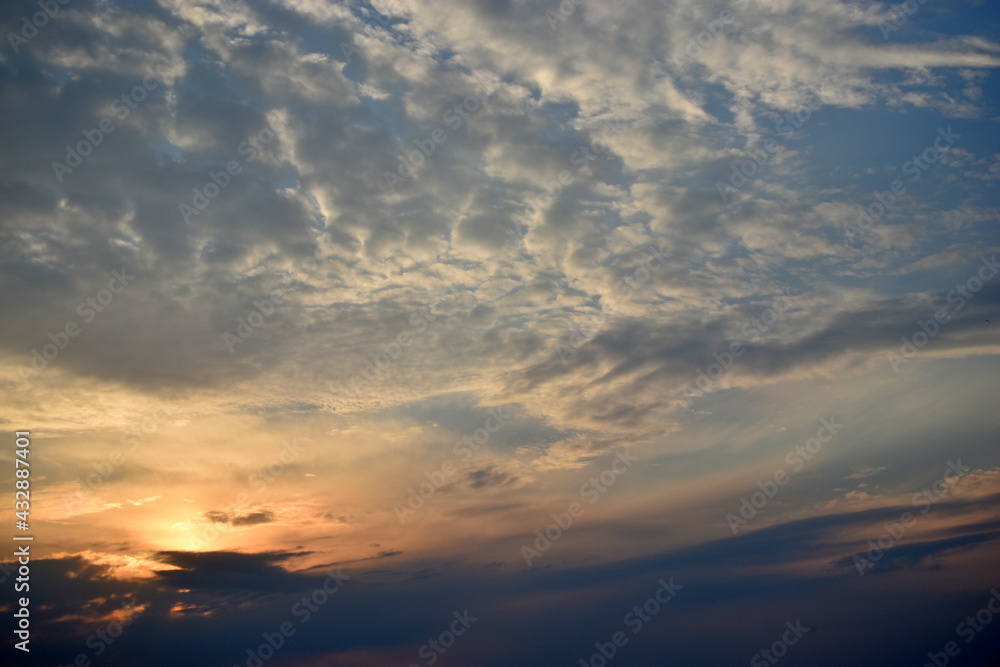 Fototapeta premium Evening sunset yellow blue sky with clouds