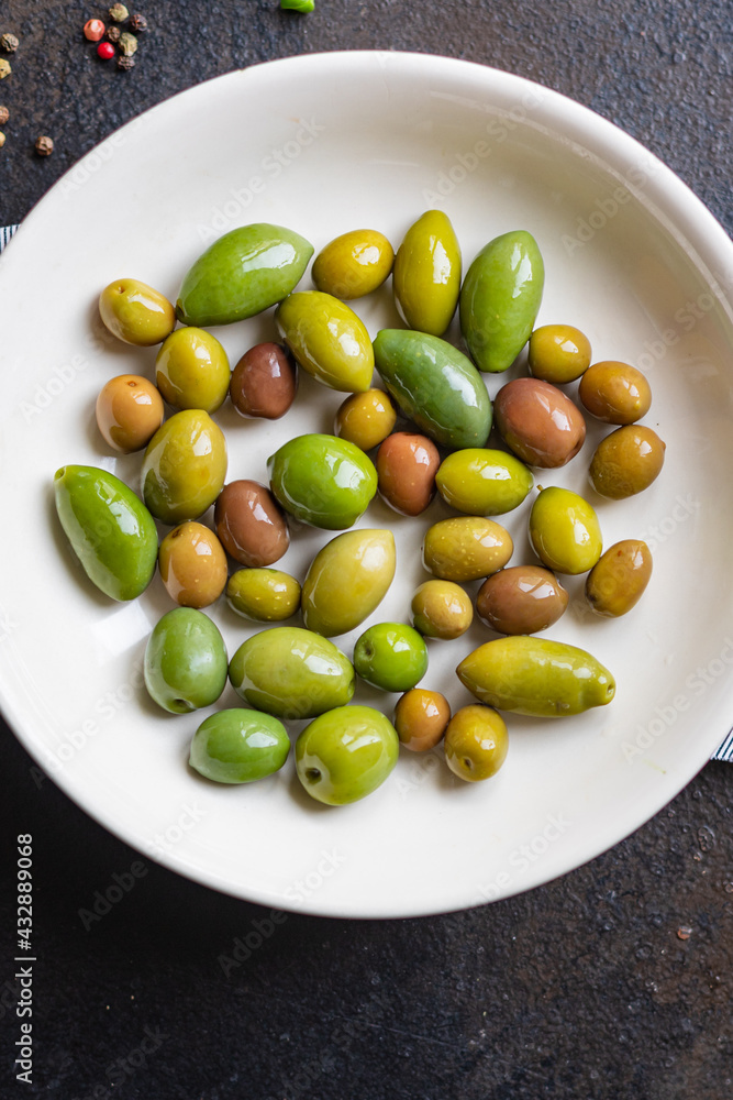 olive fruit fresh olives pitted in plate on the table veggie varieties vegan vegetarian food snack trend meal copy space food background rustic top view olive fruit fresh olives pitted in plate on the table veggie varieties vegan vegetarian food snack trend meal copy space food background rustic top view