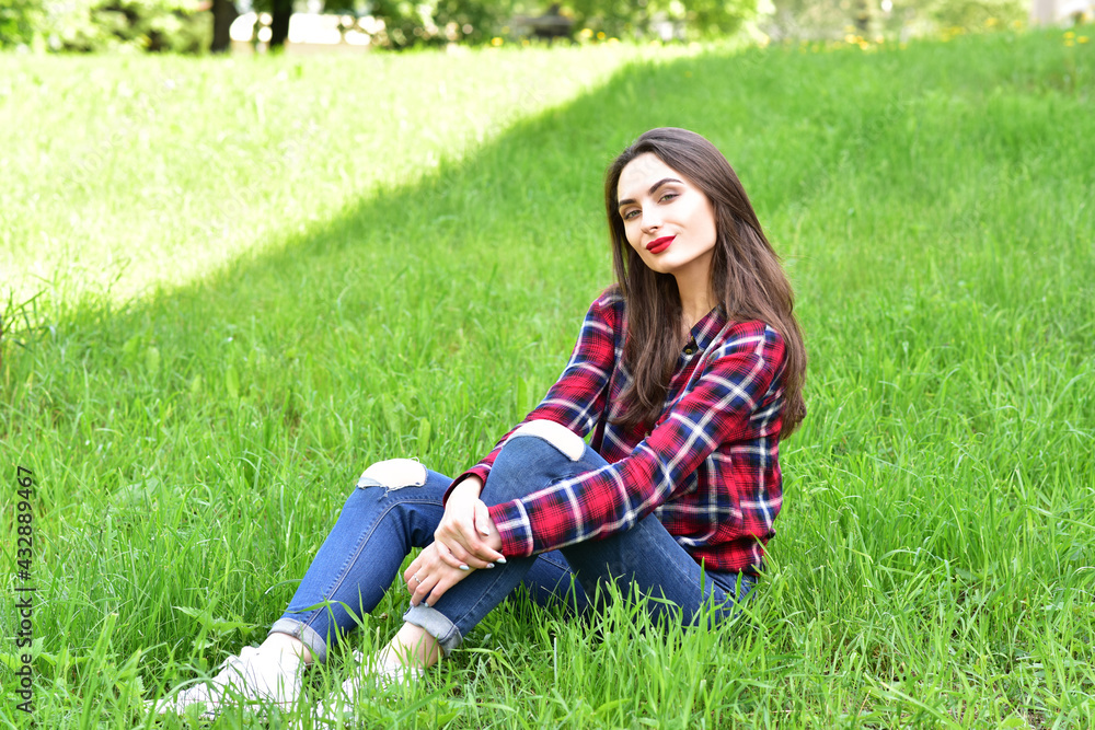 Beautiful Young Woman Outdoors. Enjoy Nature. Healthy Smiling Girl in Green Grass. Beautiful Young Woman Outdoors. Enjoy Nature. Healthy Smiling Girl in Green Grass.