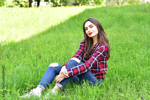 Beautiful Young Woman Outdoors. Enjoy Nature. Healthy Smiling Girl in Green Grass.