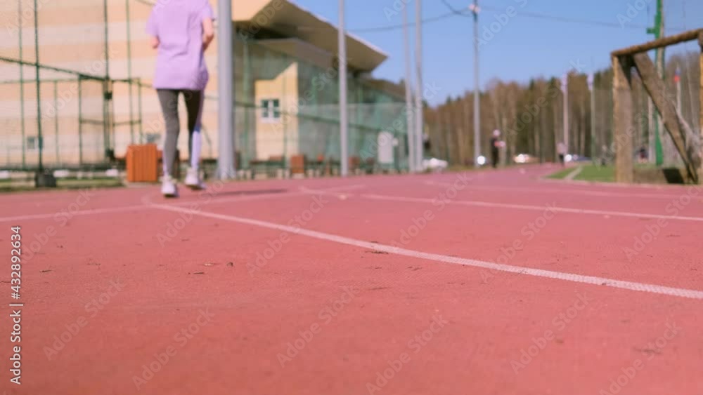 A woman runs on a outdoor treadmill. Focus on sneakers. The concept of sports, cardio training, weight loss, healthy lifestyle. A woman runs on a outdoor treadmill. Focus on sneakers. The concept of sports, cardio training, weight loss, healthy lifestyle.