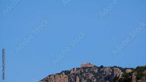 ermita románica en cima de la montaña de la cordillera pirenaica, construida en piedra, mirador con barandilla de madera, vista desde camarasa, lerida, españa, europa  photo