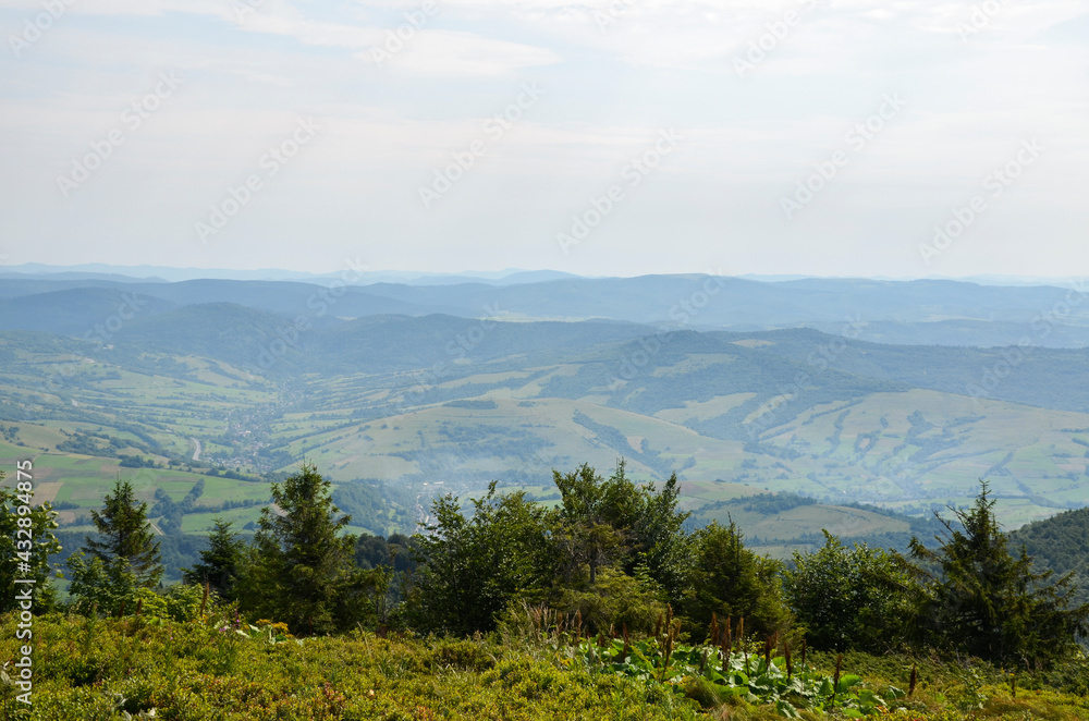 View from above of the hills mountains and fir trees home buildings in the village in summer season Carpathian mountains, Ukraine View from above of the hills mountains and fir trees home buildings in the village in summer season Carpathian mountains, Ukraine