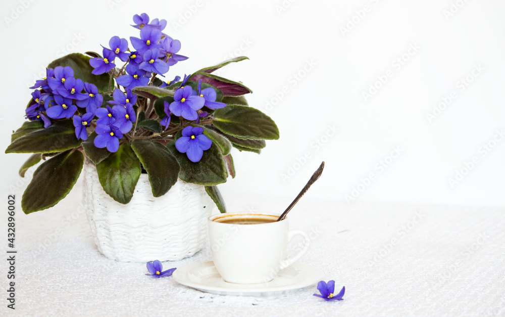 a cup of black coffee on the table with a homemade violet flower with a copy of the space a cup of black coffee on the table with a homemade violet flower with a copy of the space