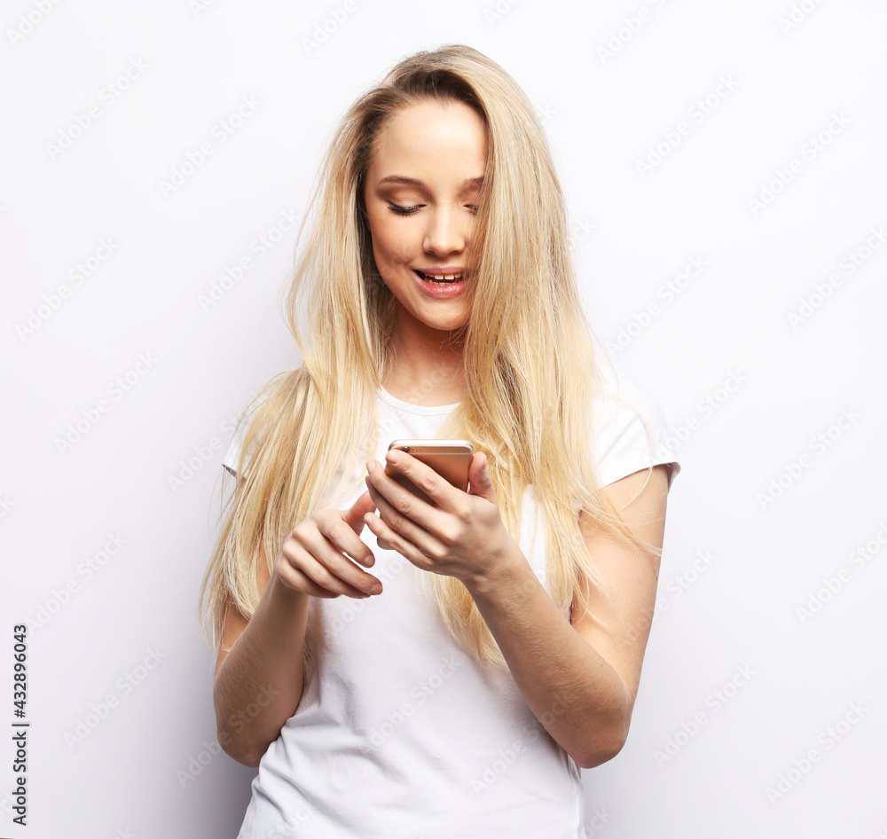 Young beautiful blond woman with smart phone Young beautiful blond woman with smart phone