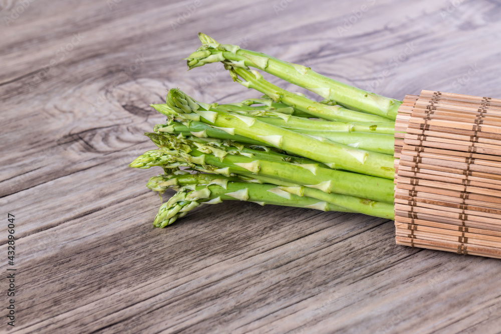 Fresh Asparagus. Bunch of fresh ripe green asparagus organic vegetables ready to cook. Group of Fresh asparagus on the wood background. Raw vegetable food for health cook