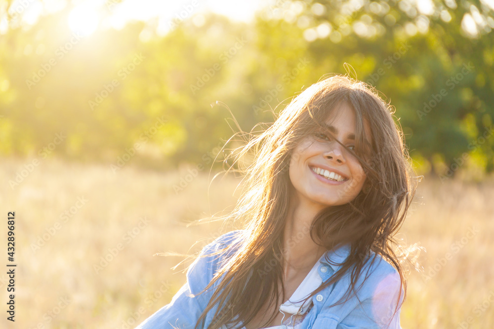 Happy girl on the field, summer sunset in a blue dress. running and spinning, the wind in hair, life style. freedom concept. Smiling moving hands turning around long hair have rest vacation Summer. Happy girl on the field, summer sunset in a blue dress. running and spinning, the wind in hair, life style. freedom concept. Smiling moving hands turning around long hair have rest vacation Summer.