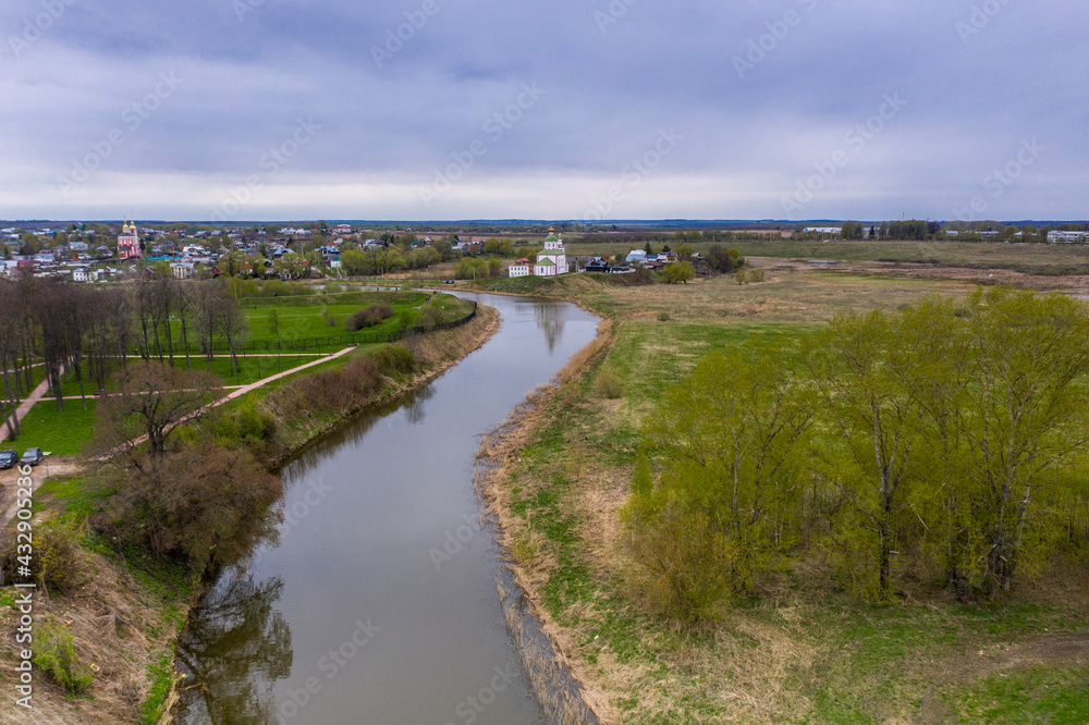 a panoramic view of the historical center of the temples and monasteries of the city of Suzdal in the rain filmed from a drone 