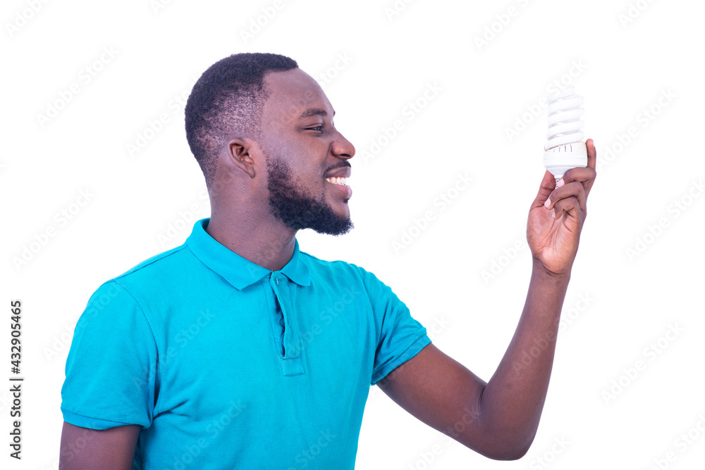 handsome happy young man holding a light bulb smiling. handsome happy young man holding a light bulb smiling.