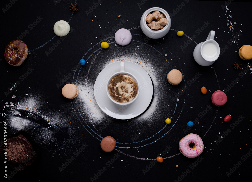 Fototapeta premium cup of coffee, donuts, macaroons, sugar, milk cream jug and cakes on the black background look like coffee system