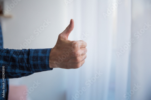 men's right hand blue shirt thumbs up photo close up