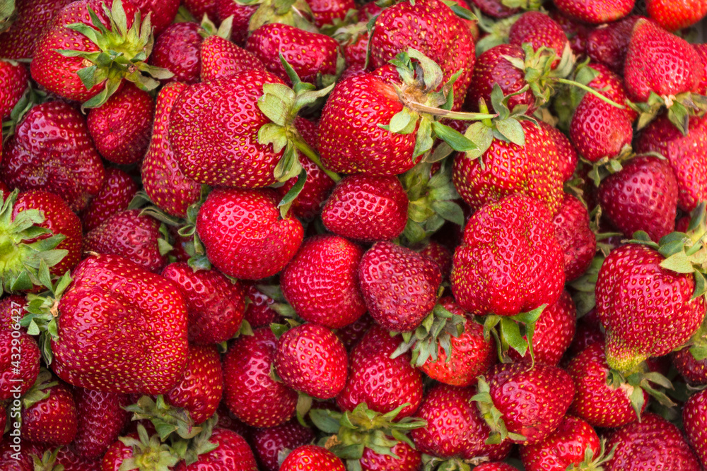 many strawberries in a market, summer background many strawberries in a market, summer background