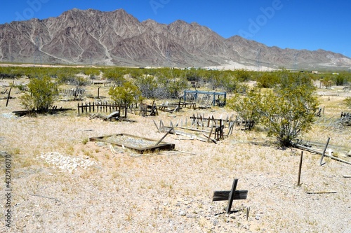 Gravesites along with a desert mountain background at the Eldorado Valley Pet Cemetary, Boulder City, Clark County Nevada.